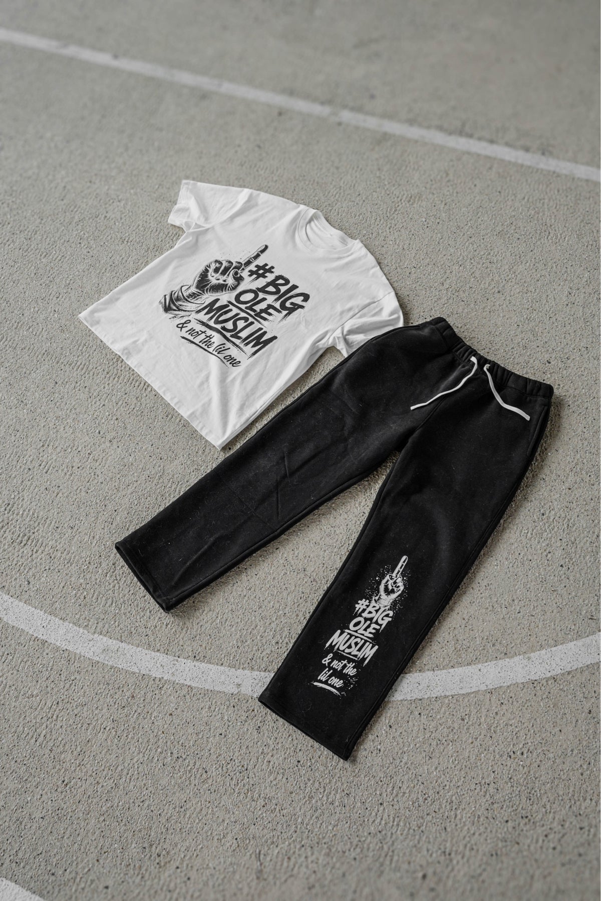 BOM Signature Tee White and BOM Straight-Leg Sweatpant Black flat lay on court