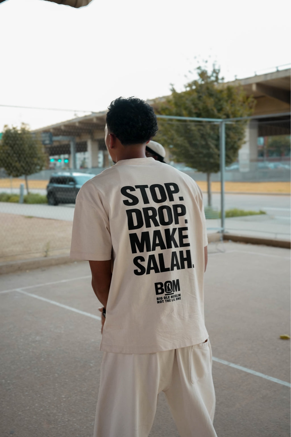 Stop Drop Make Salah cream tee back print on model