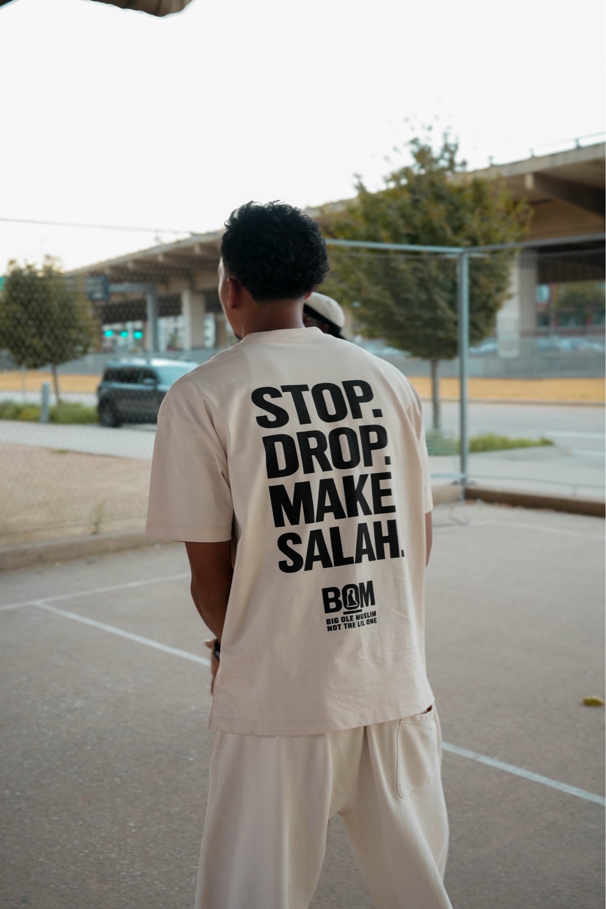 Stop Drop Make Salah cream tee back print on model