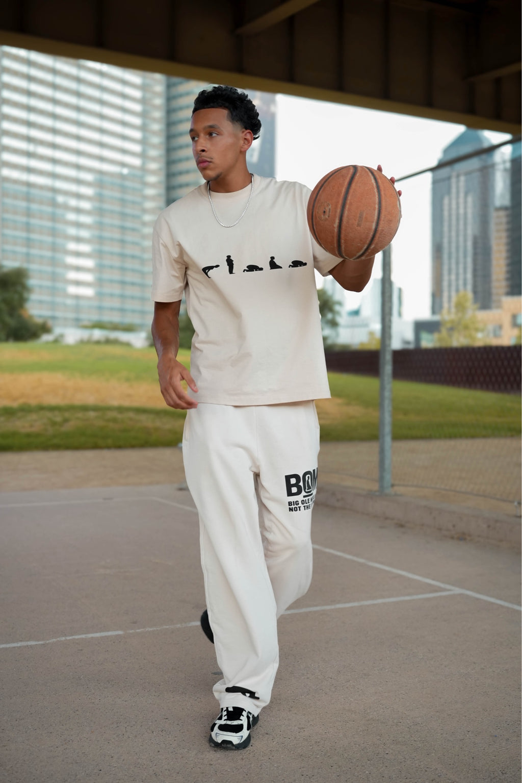 Cream Make Salah tee and bone straight-leg sweatpant on model with basketball