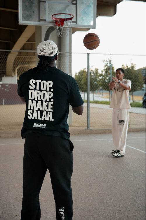 Stop Drop Make Salah black tee and black fleece pant back view