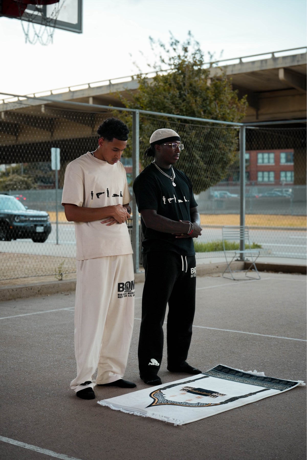 Cream and black Make Salah tees on models with prayer mat