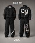 Close-up of black AYAT Signs 101 jacket and pants with white Arabic artwork